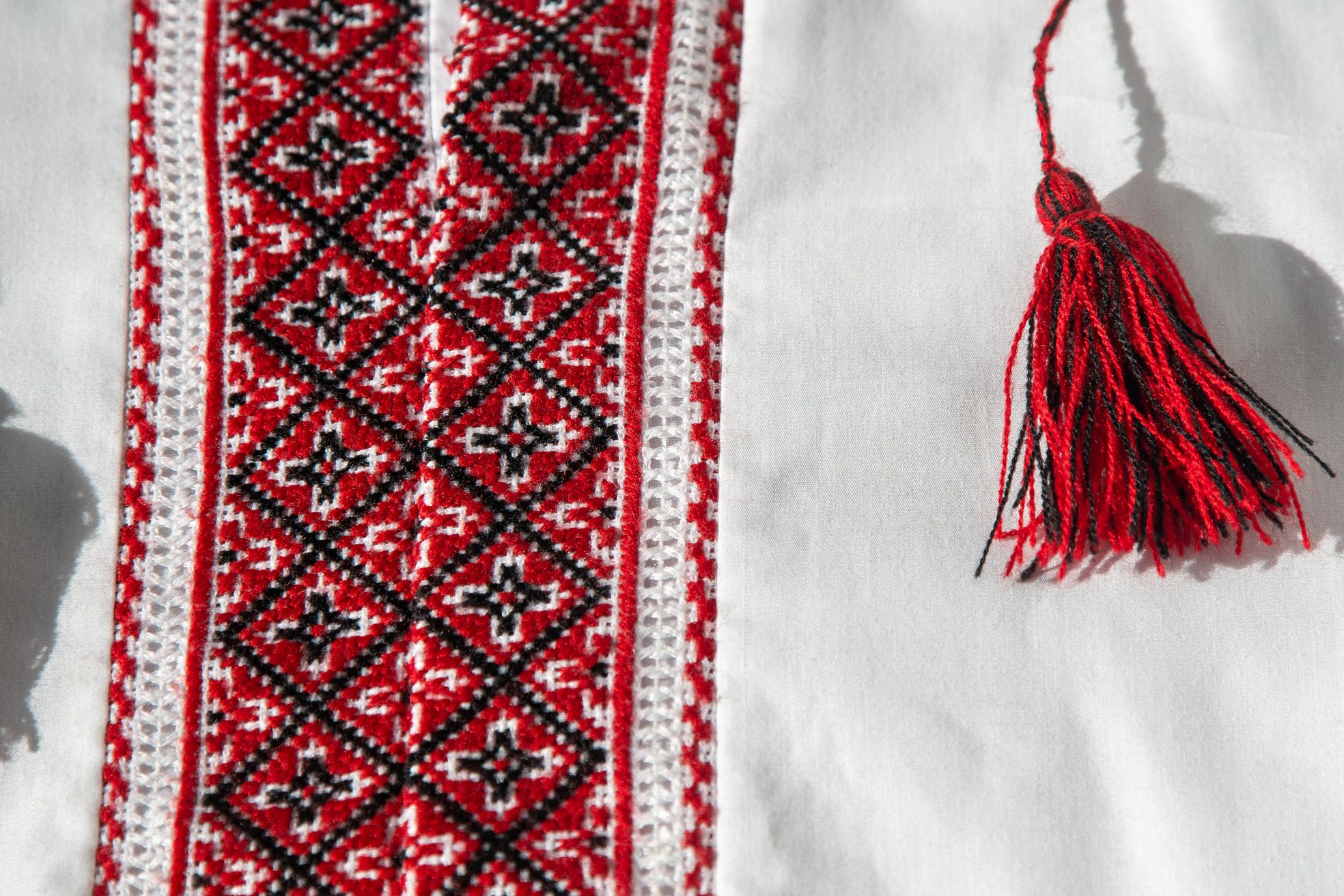 Ukrainian Clothes Embroidered Shirt. Red Orange and Black Threads Background. Vyshyvanka Is a Symbol of Ukraine. Embroidery Cross Stitching. National Ukrainian Stitch. Traditional Clothing Symbol